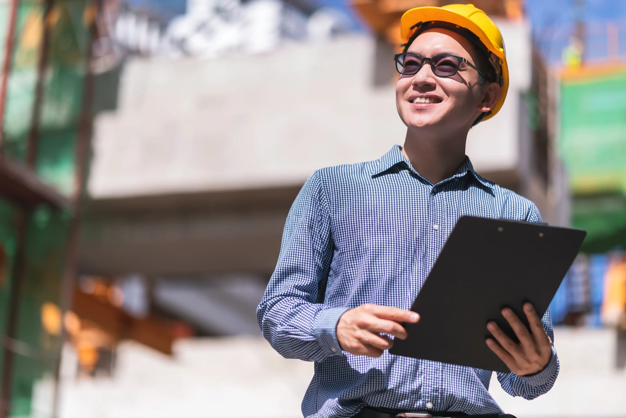 smart-asian-engineer-manager-with-safety-uniform-checking-site-construction-with-steel-concrete-structure-background